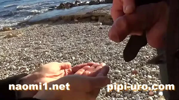 public pissing couple on a beach